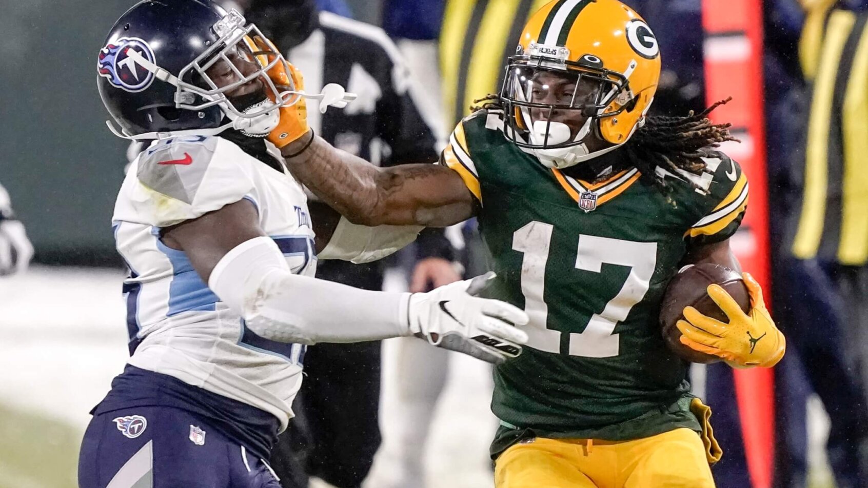 Green Bay Packers' Davante Adams trying to get past Tennessee Titans' Malcolm Butler during a game.