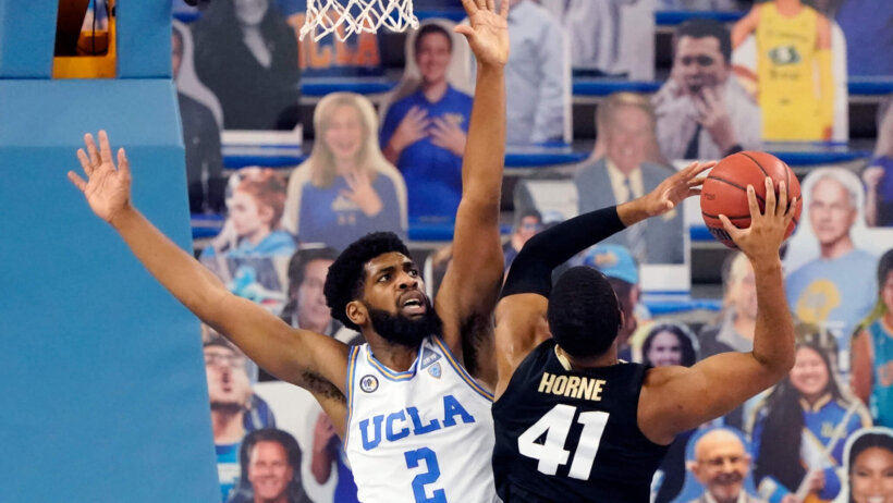 UCLA forward Cody Riley left, defending Colorado forward Jeriah Horne during a college basketball game.