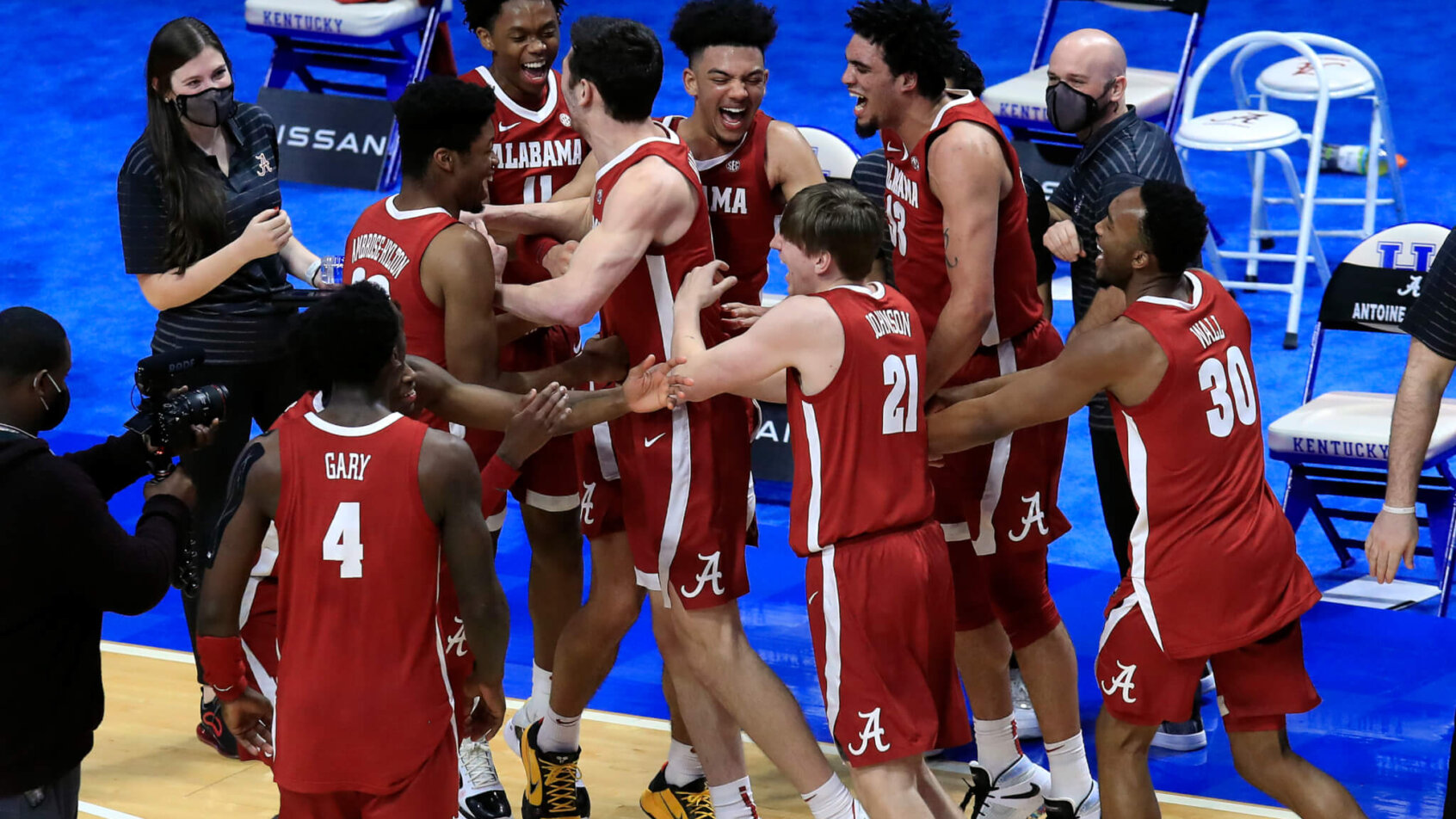Alabama players celebrating by their bench