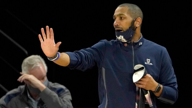 LaVall Jordan holding right hand out directing players with mask on