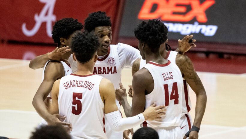 Alabama players huddling on the court