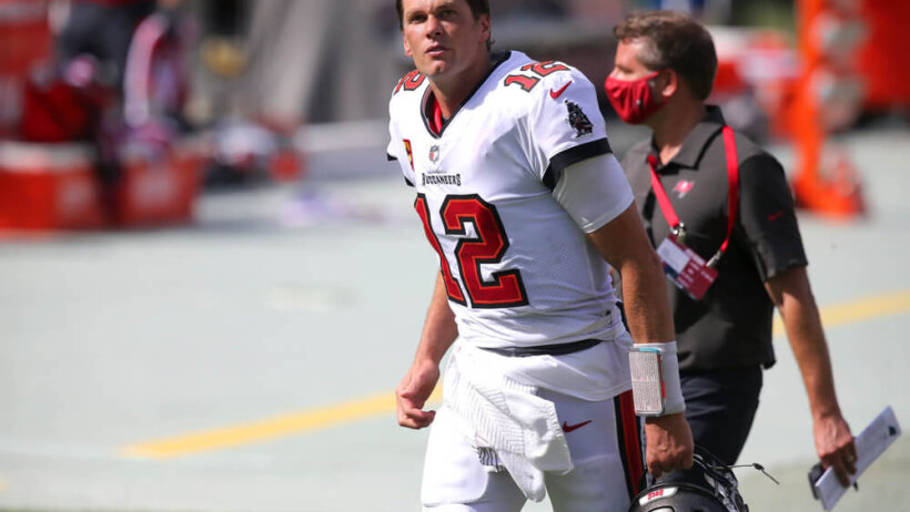 Tom Brady runs onto the field