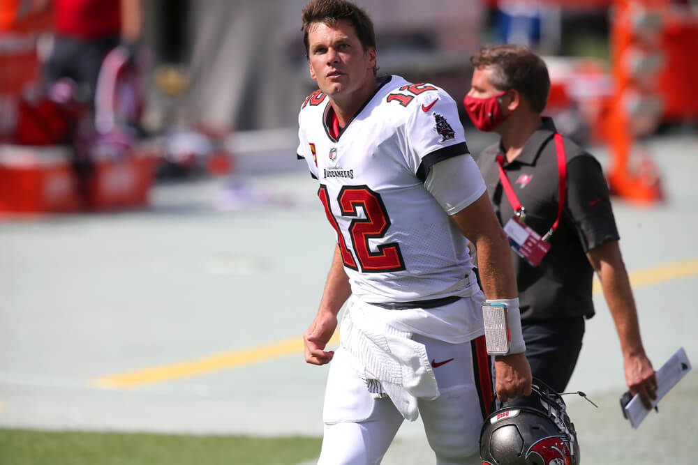 Tom Brady runs onto the field