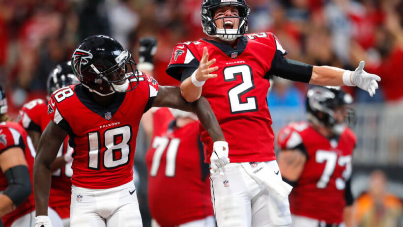 Calvin Ridley and Matt Ryan of the Atlanta Falcons celebrating on the field.