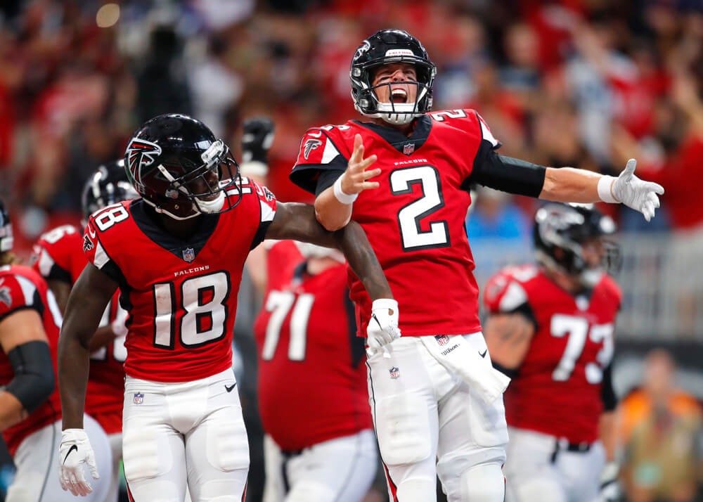 Calvin Ridley and Matt Ryan of the Atlanta Falcons celebrating on the field.