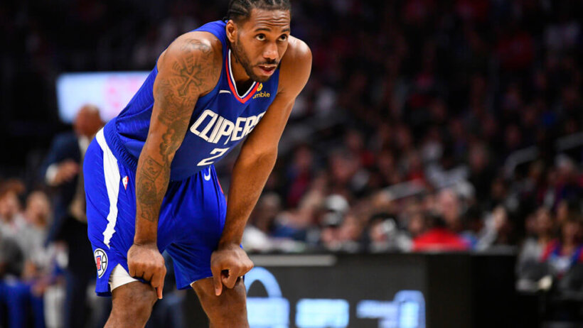 Kawhi Leonard bending over with hands on shorts