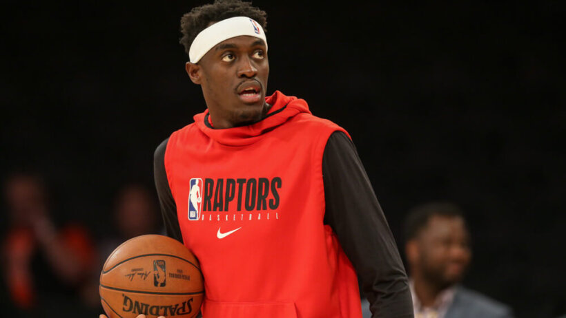 Pascal Siakam in warmus holding a basketball