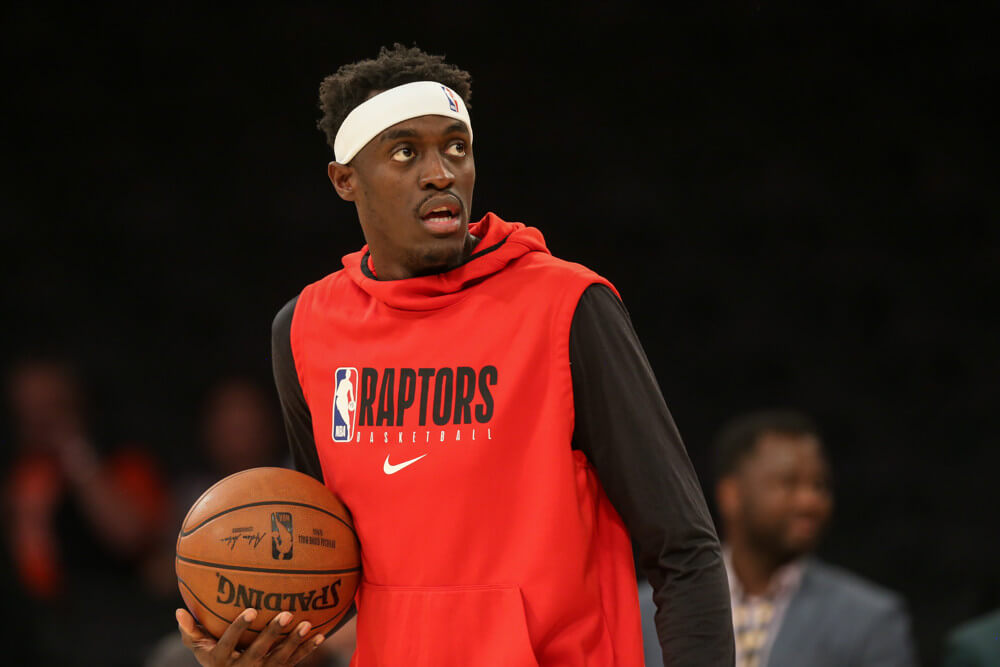 Pascal Siakam in warmus holding a basketball