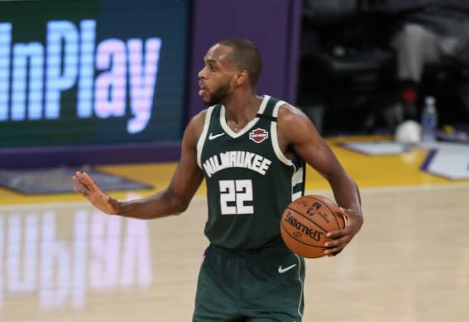 Khris Middleton holding ball and talking to team at halfcourt