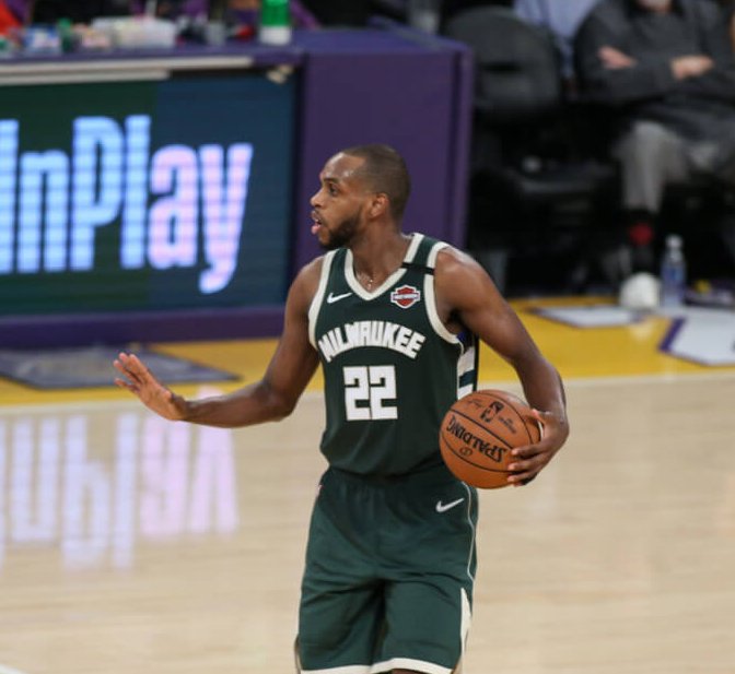 Khris Middleton holding ball and talking to team at halfcourt