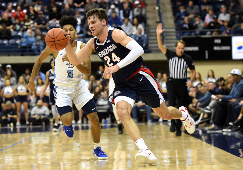 Corey Kispert (F) drives towards the basket