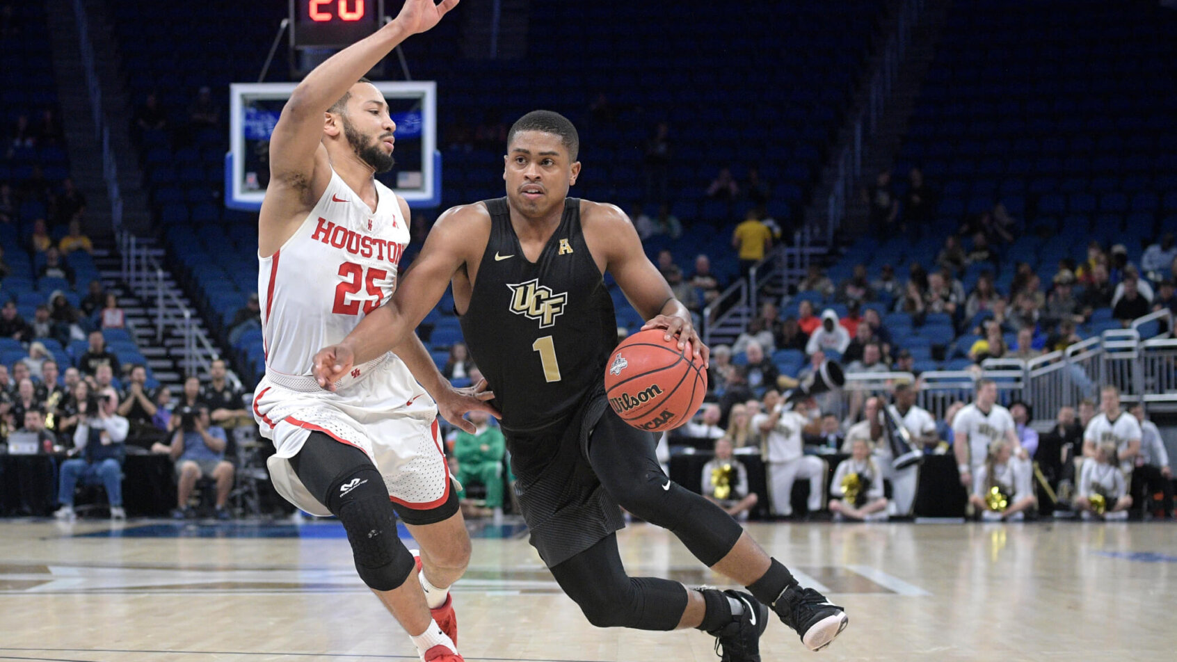 Central Florida guard B.J. Taylor (1) drives to the basket in front of Houston guard Galen Robinson Jr
