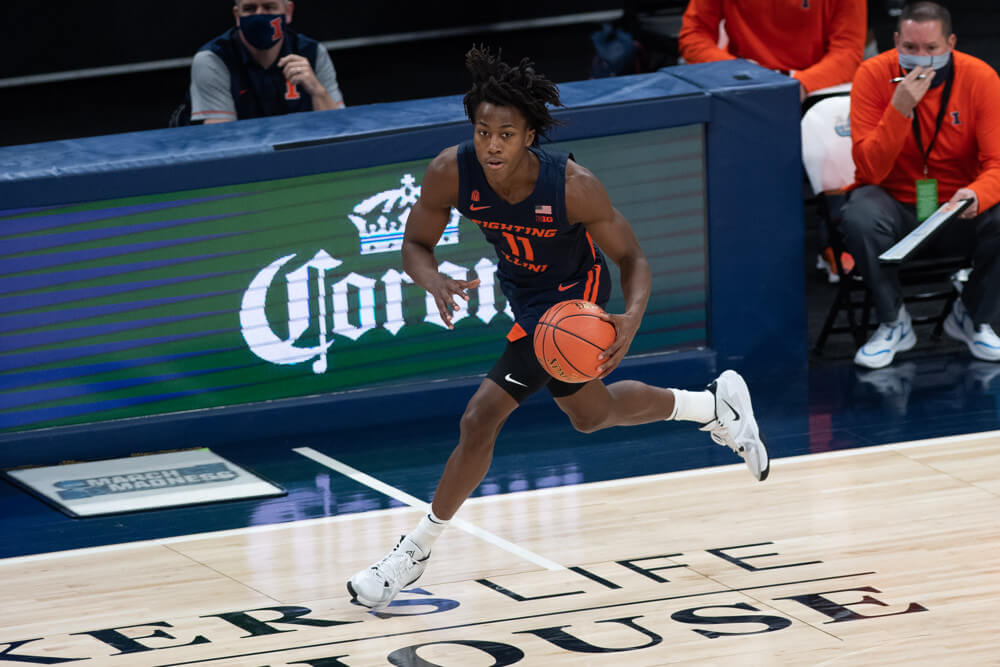 Illinois Fighting Illini guard Ayo Dosunmu dribbling the ball up the court