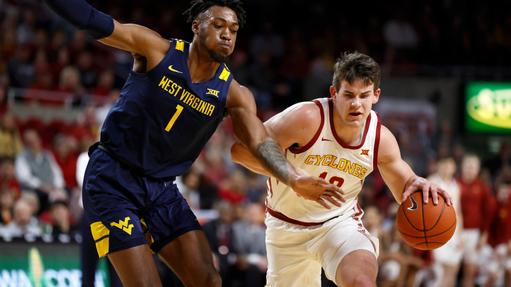 Iowa State forward Michael Jacobson drives to the basket as West Virginia forward Derek Culver defends