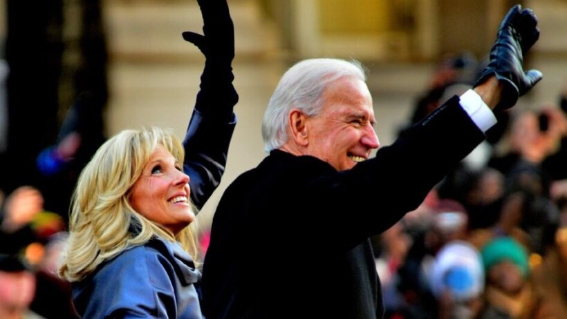 Joe and Jill Biden smiling and waving to a crowd