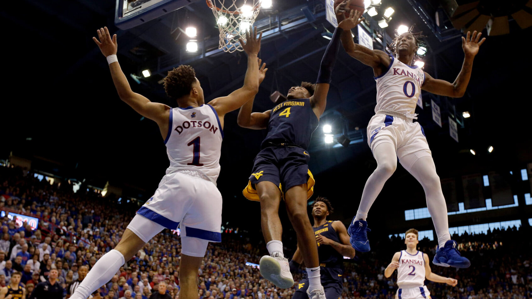 Kansas' Marcus Garrett knocks the ball away from West Virginia's Miles McBride