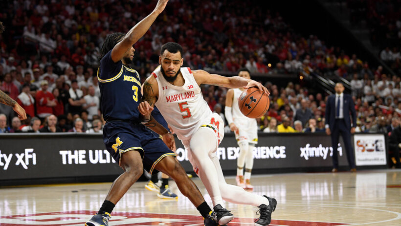 Maryland guard Eric Ayala dribbles the ball against Michigan guard Zavier Simpson