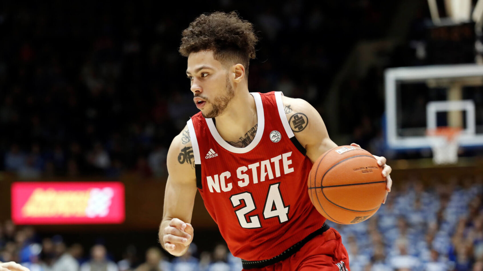 North Carolina State guard Devon Daniels) dribbling the ball up the court
