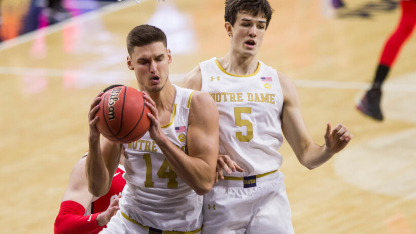 Notre Dame's Nate Laszewski (14) grabs a rebound next to teammate Cormac Ryan (5)