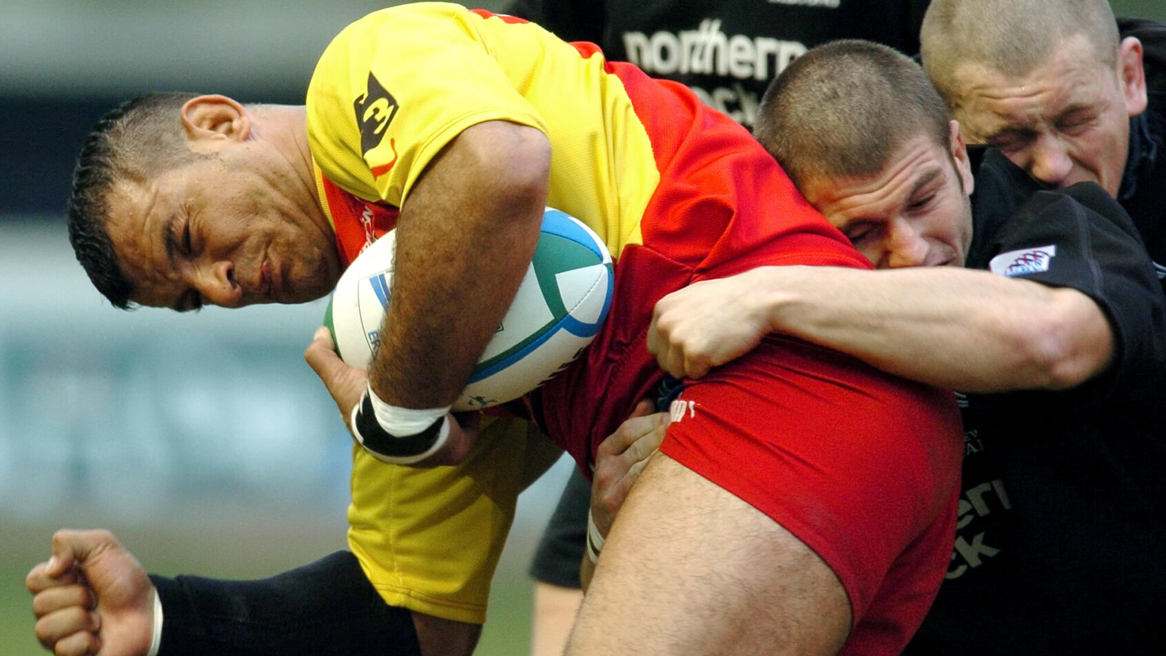 Perpignan's Bernard Gouta is tackled by Newcastle Falcon's Tom May