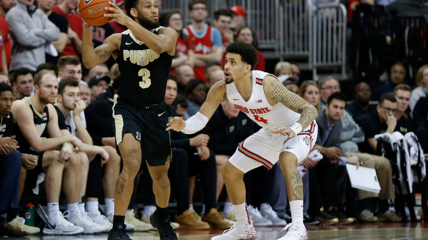 Purdue's Jahaad Proctor looks for an open pass as Ohio State's Duane Washington defends
