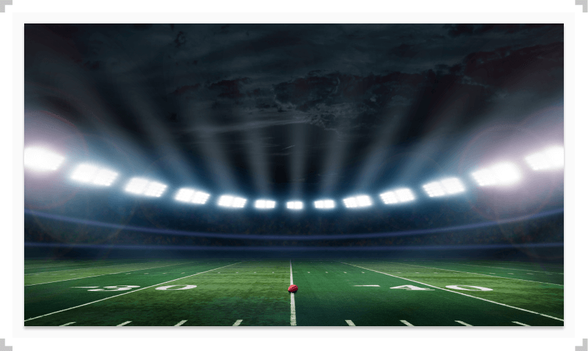 Empty football stadium with a football on the field