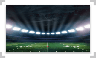Empty football stadium with a football on the field