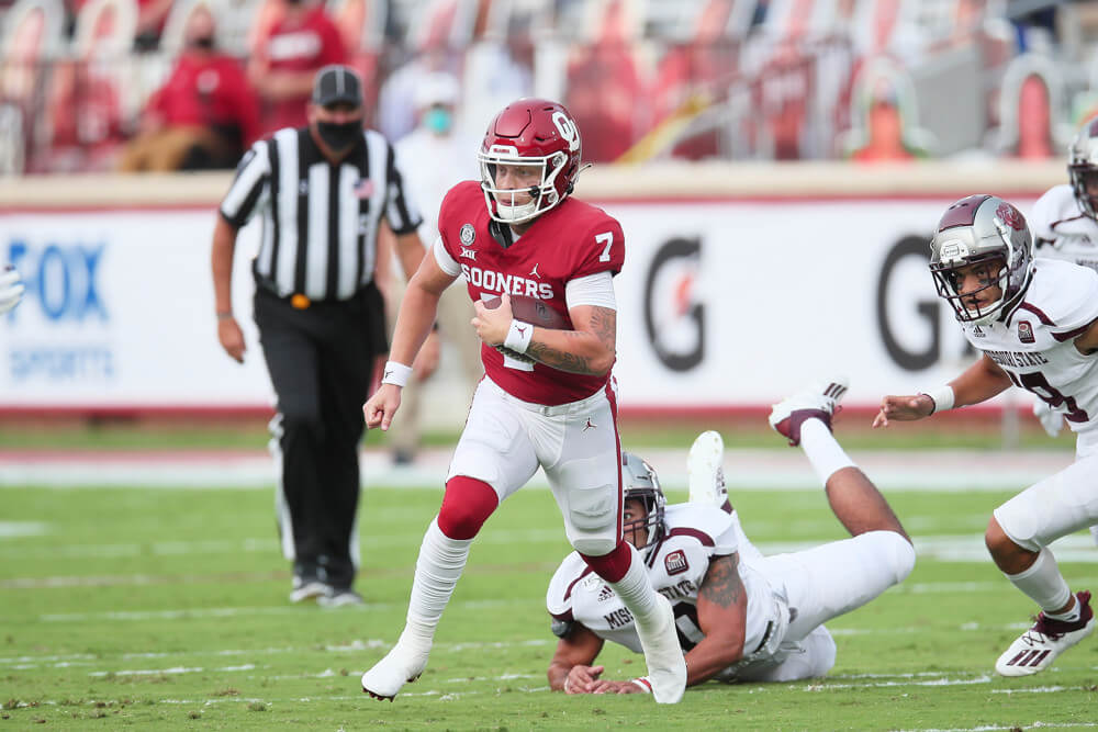 Spencer Rattler of the Oklahoma Sooners running the ball.