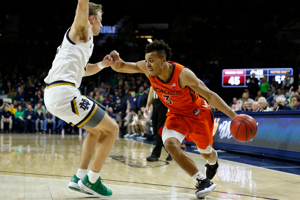 Virginia Tech Hokies guard Wabissa Bede dribbling around a defender