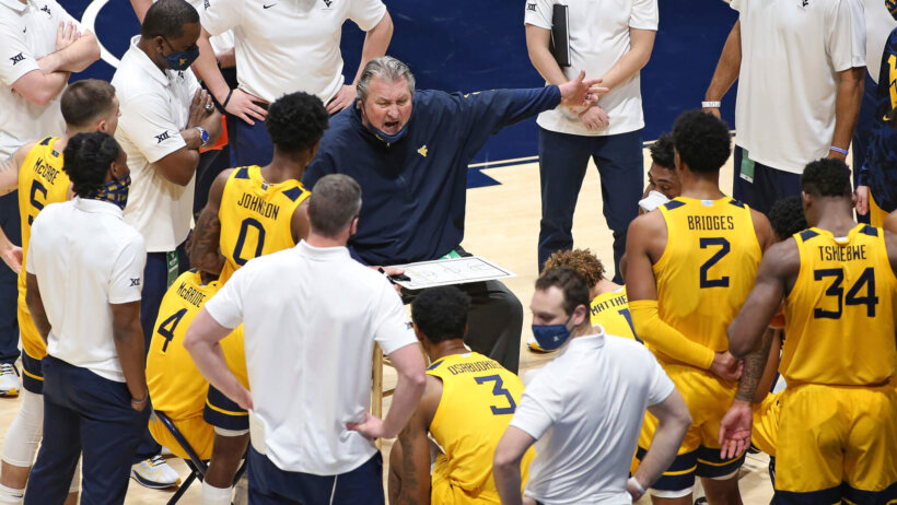 West Virginia coach Bob Huggins speaks with players