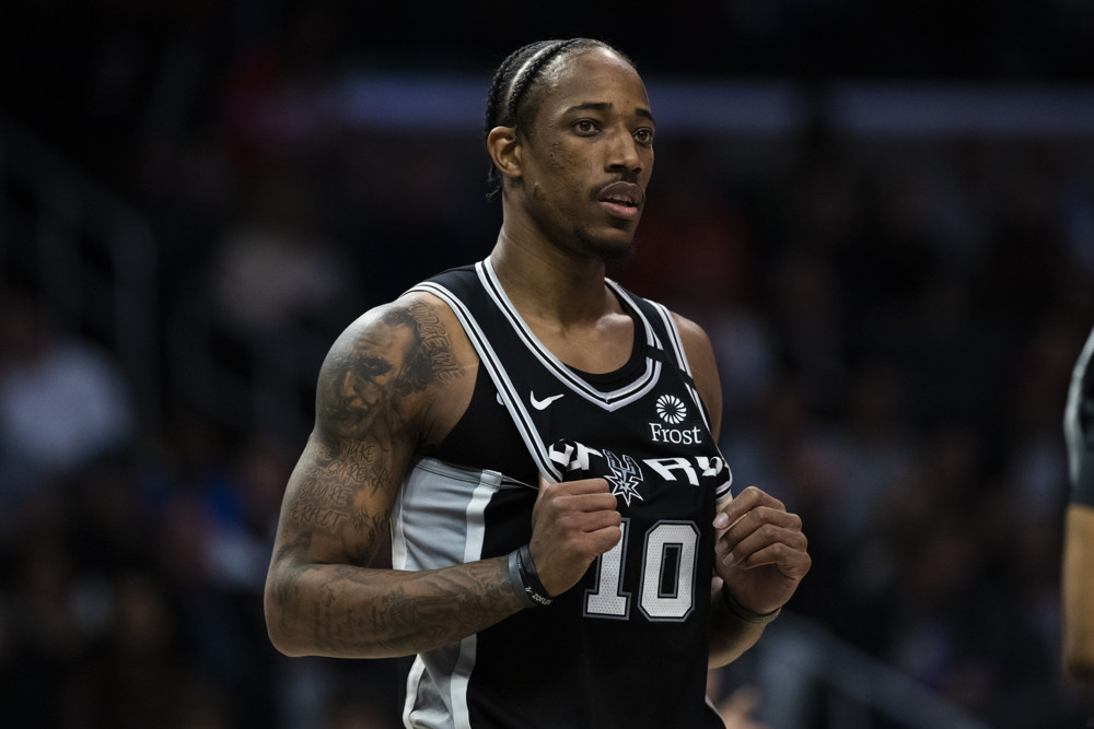 DeMar DeRozan holding front of jersey