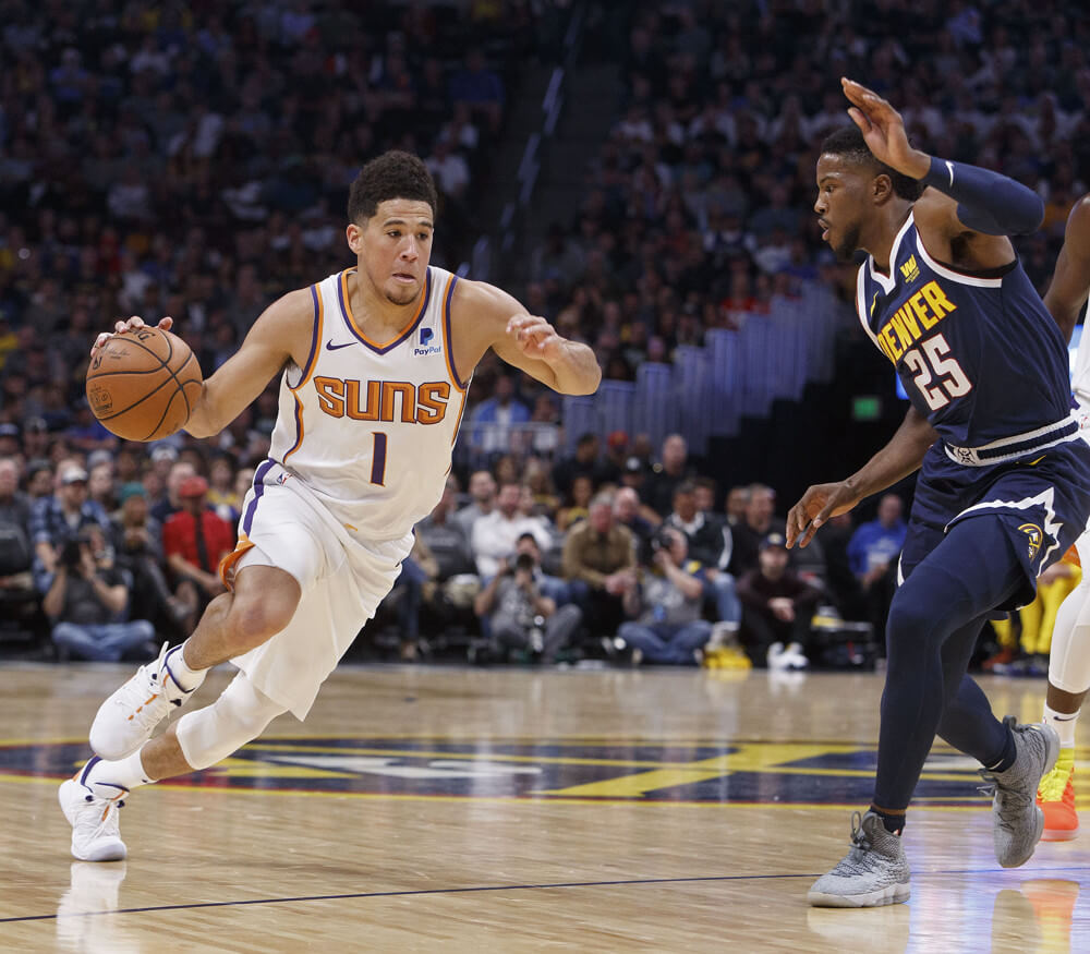 Devin Booker driving by opponent