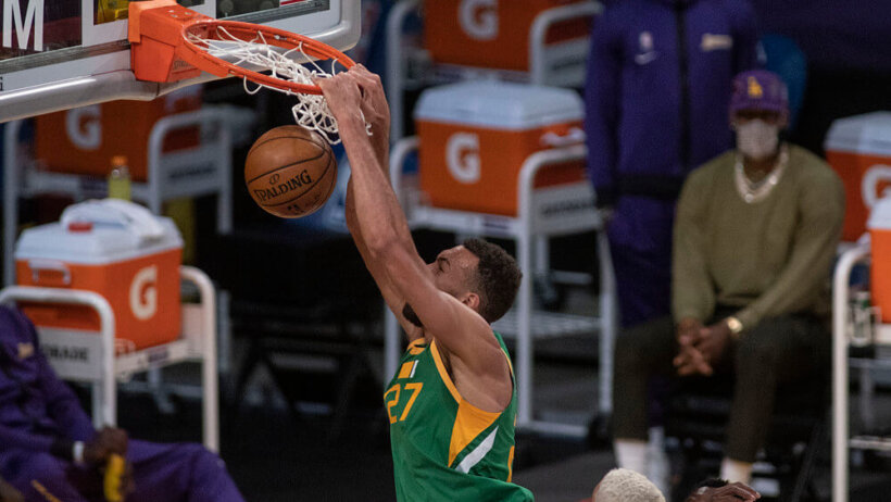 Rudy Gobert dunking the ball during a NBA game.