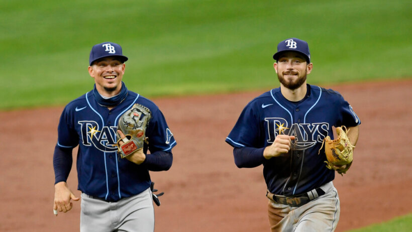 Tampa Bay Rays shortstop Willy Adames and second baseman Brandon Lowe smile as they jog off the field