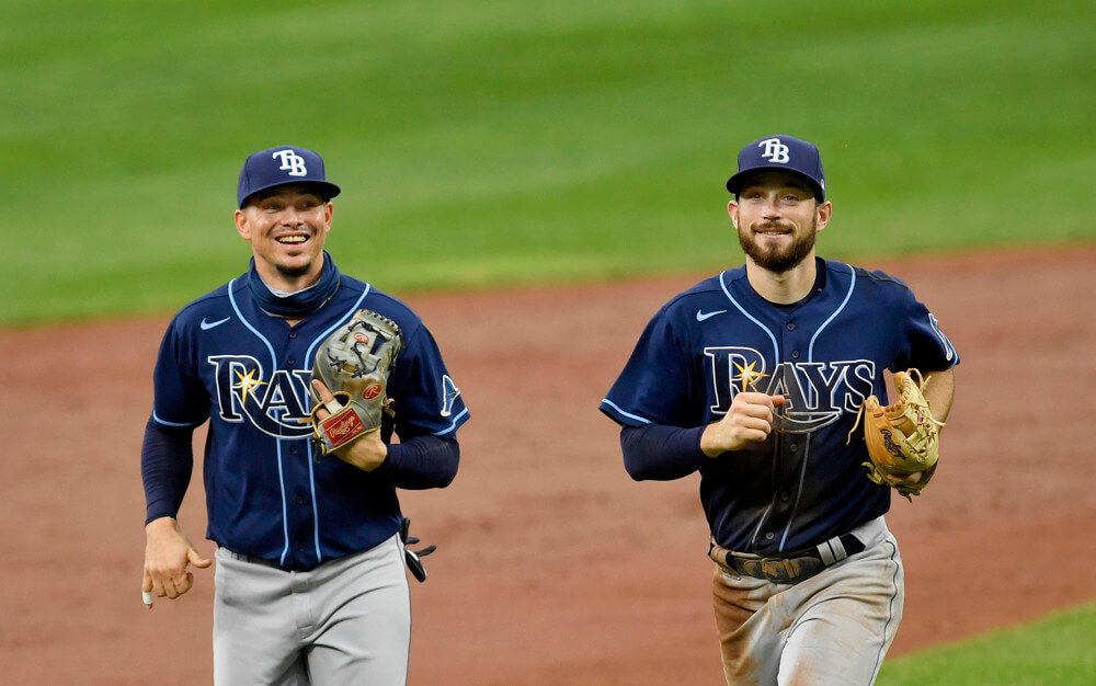 Tampa Bay Rays shortstop Willy Adames and second baseman Brandon Lowe smile as they jog off the field