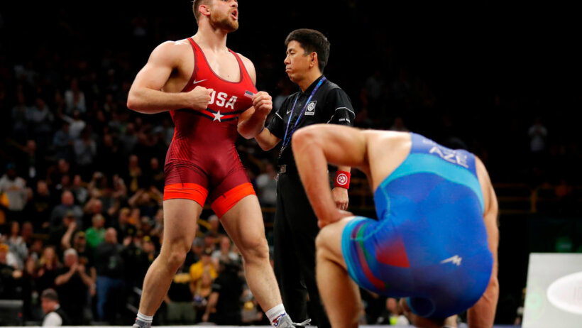 David Taylor celebrating after defeating Aleksander Gostiev in their freestyle wrestling match.