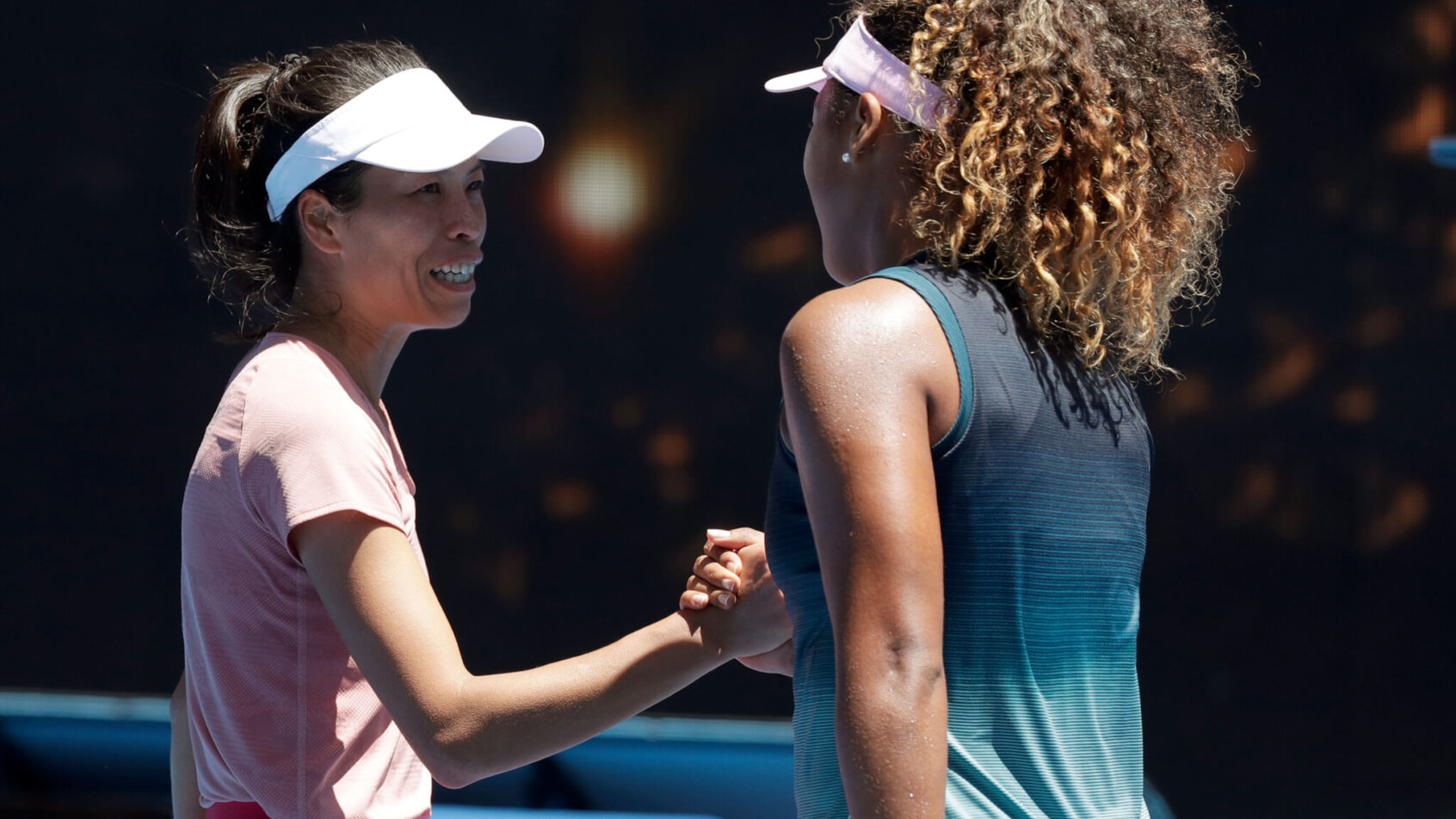Naomi Osaka and Hsieh Su-Wei engaging at the net after their match.
