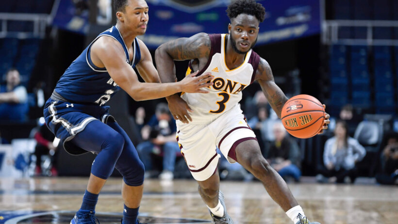 Asante Gist driving by defender
