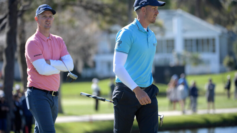 Justin Rose and Henrik Stenson walk on the green