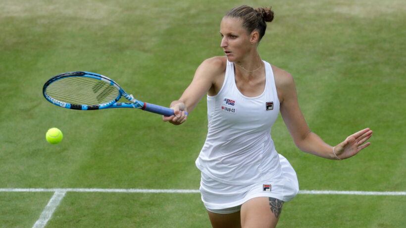 Karolina Pliskova hitting a return during a tennis match.
