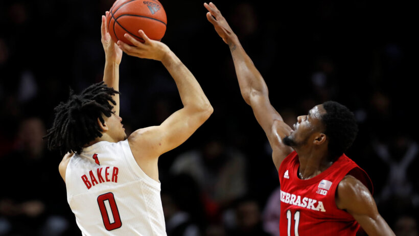 Rutgers guard Geo Baker taking a shot over Nebraska guard Dachon Burke Jr. during a NCAA men's basketball game.