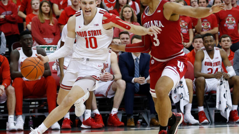 Ohio State's Justin Ahrens dribbling the ball past Indiana's Justin Smith during a NCAA men's basketball game.
