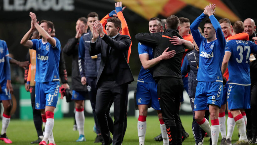 Rangers' players and manager celebrating after winning a match.