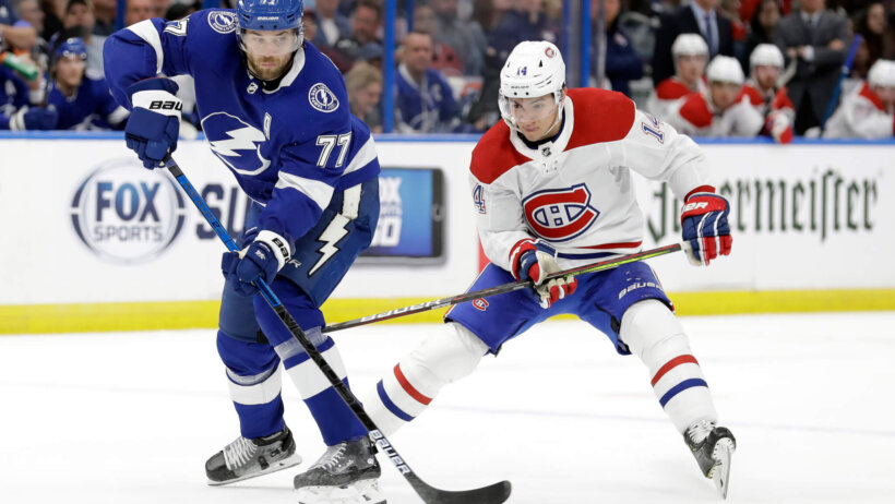 Victor Hedman and Nick Suzuki battling for puck