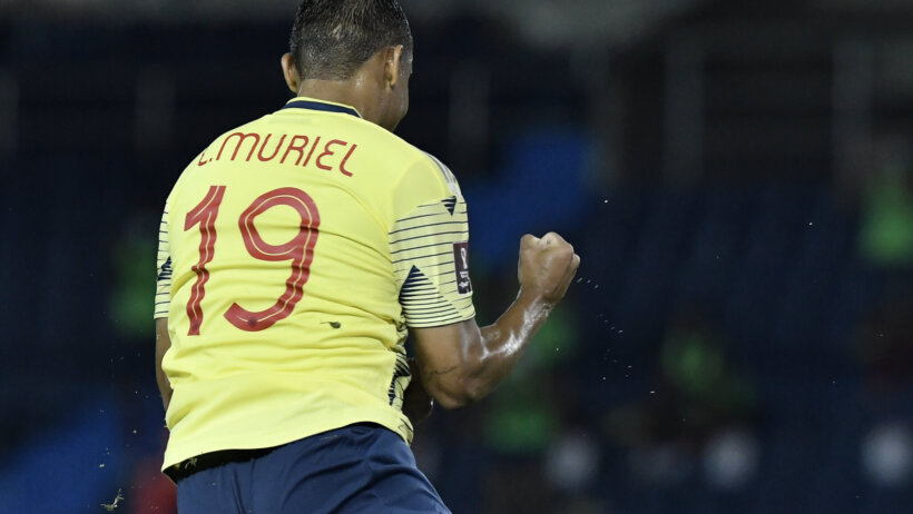 Colombia's Luis Muriel celebrating with fist pumps after scoring a goal.