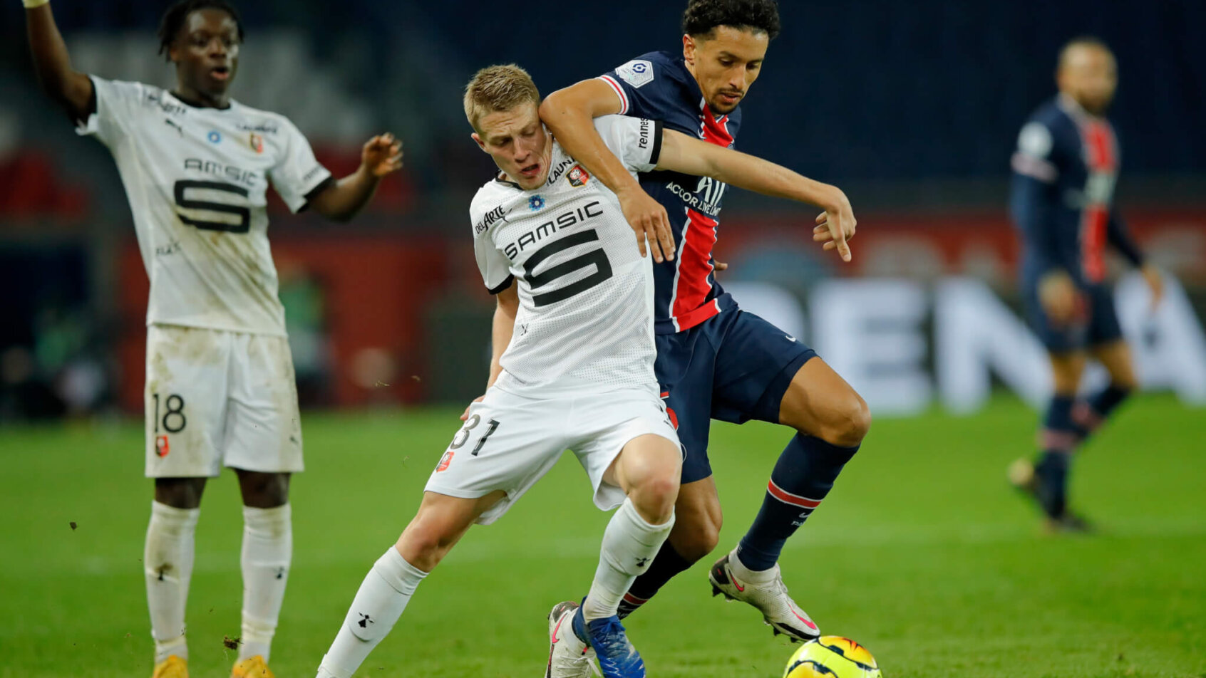 Adrien Truffert and Marquinhos fight for possession of ball