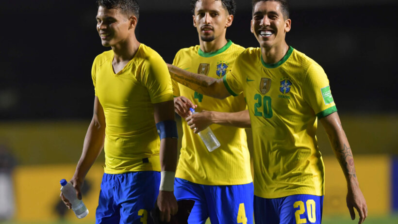 Brazil players celebrating a win at the end of a soccer match.