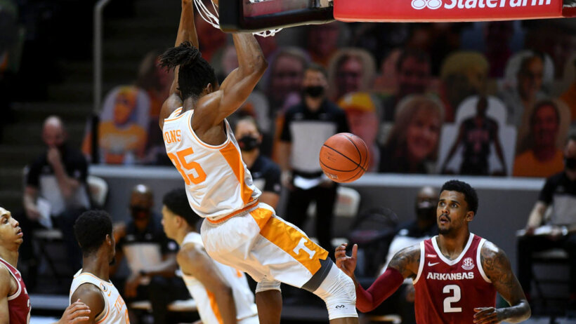 Yves Pons hanging on rim after a dunk