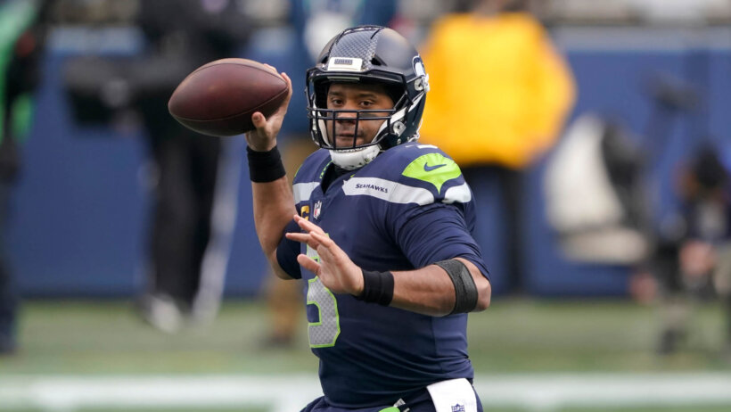 Seattle Seahawks quarterback Russell Wilson throwing a football during a NFL game.