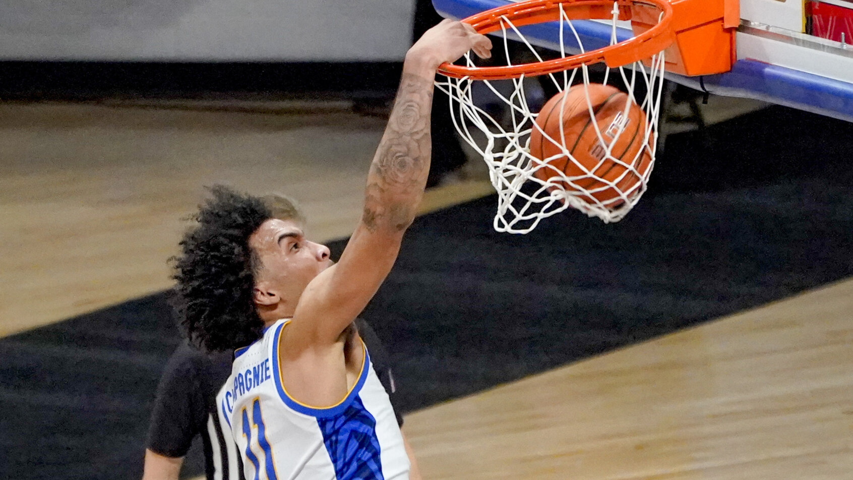 Pittsburgh's Justin Champagnie dunking during a NCAA men's basketball game.